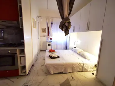 a shower with a glass door in a bathroom at Rouge Studio - 10 min from Vatican in Rome