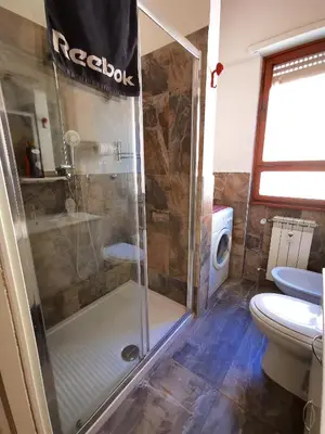 a kitchen and a bedroom with a bed in a room at Rouge Studio - 10 min from Vatican in Rome