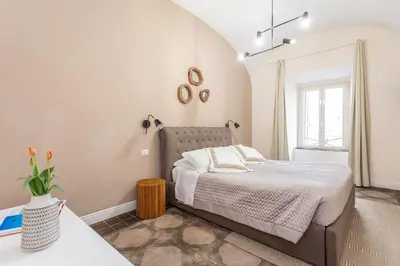 a bedroom with a bed and a window at Daplace - Lucia Apartment in Rome