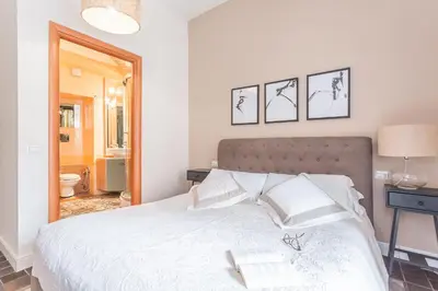 a bedroom with a large white bed with a mirror at Daplace - Lucia Apartment in Rome