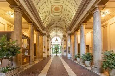an old building with columns and a ceiling at Daplace - Lucia Apartment in Rome