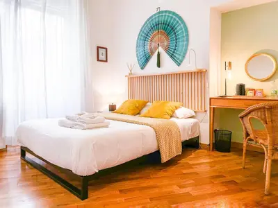 a bedroom with a bed with a table and a mirror at Testaccio B45 Guesthouse in Rome