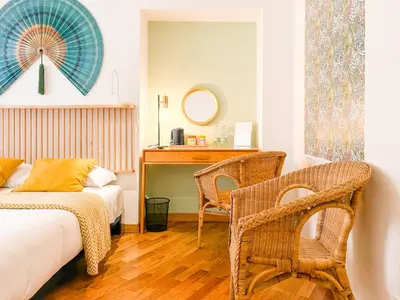 a bedroom with a bed and a desk and chairs at Testaccio B45 Guesthouse in Rome