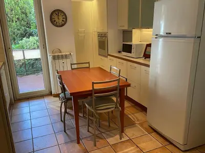 a kitchen with a wooden table and a refrigerator at Vicario138 in Rome