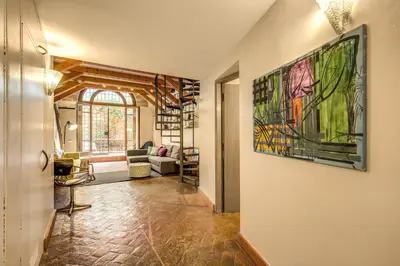 a living room with a large painting on the wall at The Smart Loft in Rome