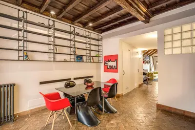 a dining room with red chairs and a table at The Smart Loft in Rome