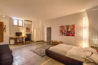 a bedroom with a bed and a desk in a room at The Smart Loft in Rome