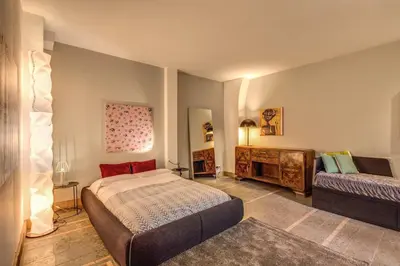 a bedroom with a bed and a couch in it at The Smart Loft in Rome