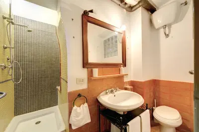 a bathroom with a sink and a toilet and a mirror at The Smart Loft in Rome