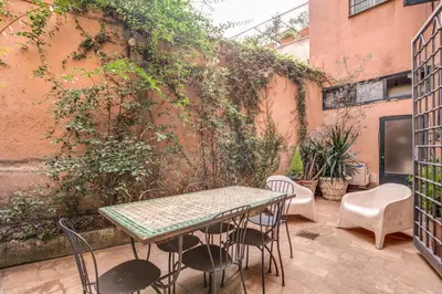 a table and chairs on a patio next to a building at The Smart Loft in Rome