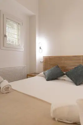a bedroom with a large white bed with two pillows at Casa Camilla in Rome