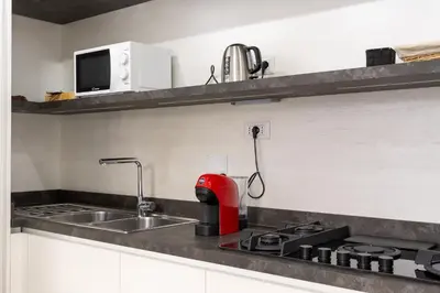 a kitchen with a sink and a red appliance at Casa Camilla in Rome