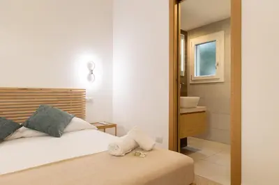 a bedroom with a bed and a bathroom with a sink at Casa Camilla in Rome