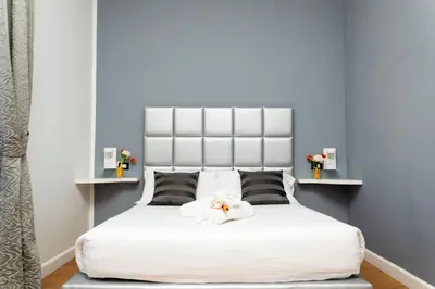 a bedroom with a white bed with two towels on it at The Cicer One in Rome
