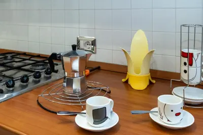 a kitchen counter with two cups and a coffee maker at Pigneto Vannini Roma in Rome