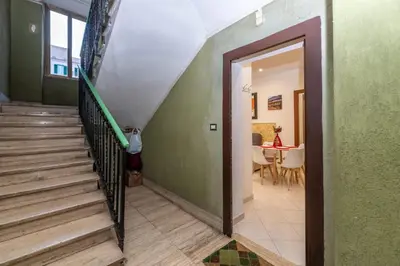 a stairway with a green wall and a stair case at Pigneto Vannini Roma in Rome