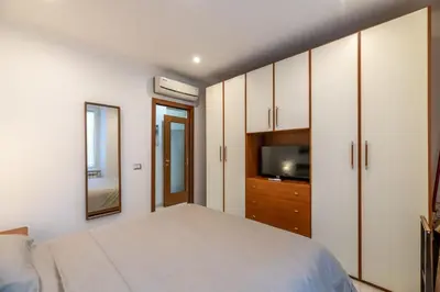 a bedroom with a bed and a tv and cabinets at Pigneto Vannini Roma in Rome