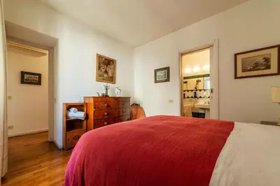 a bedroom with a bed and a dresser in it at Colosseum - Charme Holidays in Rome