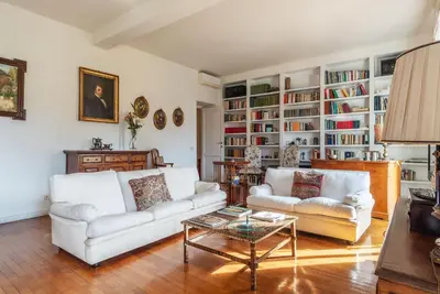 a living room with two white couches and a coffee table at Colosseum - Charme Holidays in Rome