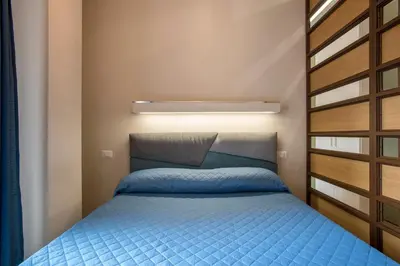 a small bedroom with a blue bed in a room at LALY LOVE in Rome