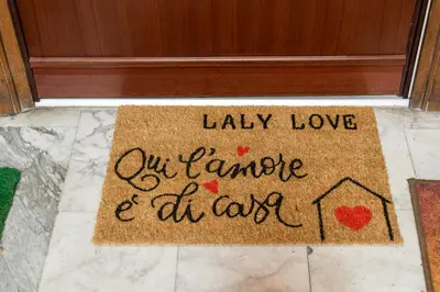 a welcome mat with the words lazy love our romance and at least at LALY LOVE in Rome