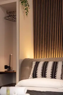 a bedroom with a bed with a black and white pillow at Domus Colosseum by JFM - Cozy apartment nearby Colosseum in Rome
