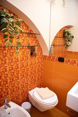 a bathroom with a toilet and a sink at Domus Colosseum by JFM - Cozy apartment nearby Colosseum in Rome