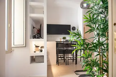 a kitchen and a dining room with plants at Domus Colosseum by JFM - Cozy apartment nearby Colosseum in Rome
