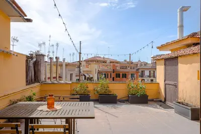 a patio with a table and chairs and buildings at La mansarda del Papa - ZENO 05 in Rome