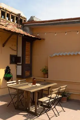 a wooden table and chairs on a patio at La mansarda del Papa - ZENO 05 in Rome