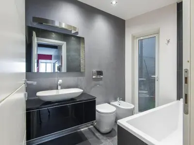 a bathroom with a sink and a toilet and a mirror at Apartment San Salvatore by Interhome in Rome