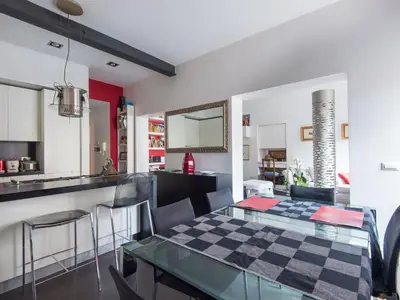 a kitchen and dining room with a checkered table and chairs at Apartment San Salvatore by Interhome in Rome
