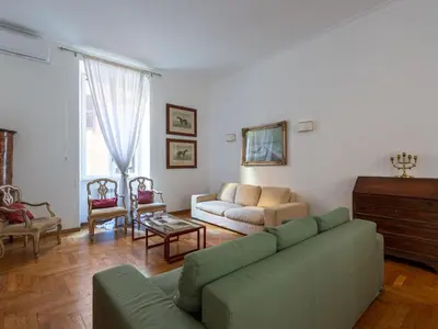 a living room with a green couch and chairs at Apartment Virgilio by Interhome in Rome