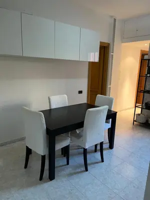 a black table and white chairs in a room at Red house in Monteverde - Cale 02 in Rome