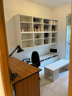 an office with a desk with a computer and a chair at Red house in Monteverde - Cale 02 in Rome