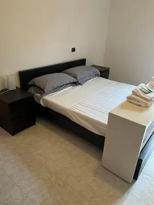 a bedroom with a bed with a nightstand and a white bed sidx sidx sidx at Red house in Monteverde - Cale 02 in Rome