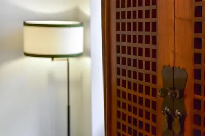 a lamp in a room next to a door at Residenza Clodio Spanish Steps in Rome