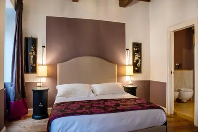 a bedroom with a large bed and two lamps at Residenza Clodio Spanish Steps in Rome