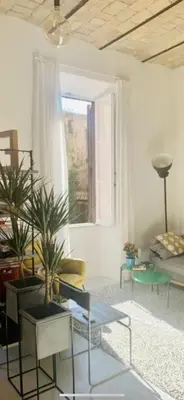 a living room with chairs and tables and a window at Sweet Life House Rome Cavour in Rome