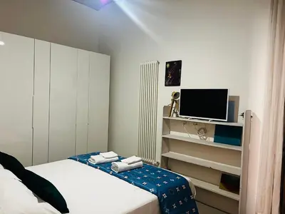 a small bedroom with a bed and a tv at Sweet Life House Rome Cavour in Rome