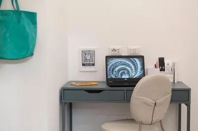 a desk with a computer and a chair at Veniero37 Guest House in Rome