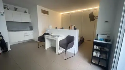 a small white kitchen with two chairs and a table at GreenSpace Romantic Studio - Piazza del Popolo in Rome