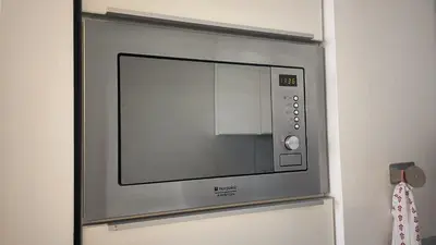 a microwave oven on a wall in a room at GreenSpace Romantic Studio - Piazza del Popolo in Rome