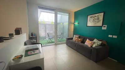 a living room with a couch and a green wall at GreenSpace Romantic Studio - Piazza del Popolo in Rome