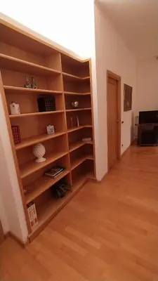 a room with wooden shelves and a hallway at Lovely Suite accogliente appartamento tra Policlinico e Piazza Bologna in Rome