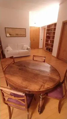 a living room with a wooden table and a couch at Lovely Suite accogliente appartamento tra Policlinico e Piazza Bologna in Rome