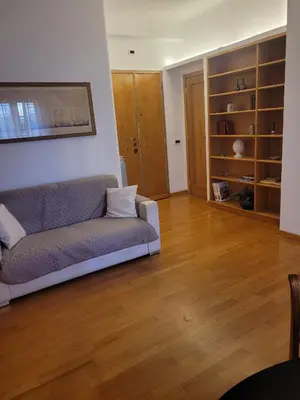 a living room with a couch and wooden floors at Lovely Suite accogliente appartamento tra Policlinico e Piazza Bologna in Rome