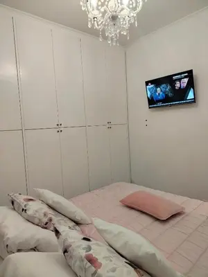 a bedroom with a bed and a tv on the wall at Casina Tiberina Suite in Rome