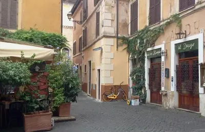 a street with buildings and a bike parked on a street at Casina Tiberina Suite in Rome