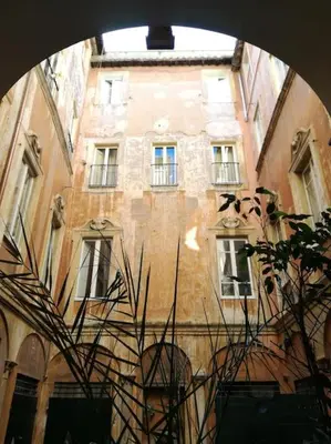 a tall brick building with many windows on it at Apartment in a 1400s building in Via dei Coronari Piazza Navona in Rome